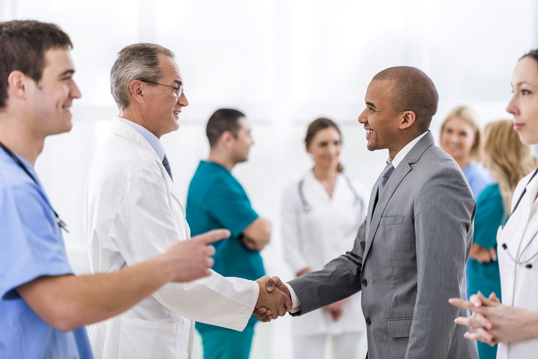 Doctors shaking hands with colleagues and partners